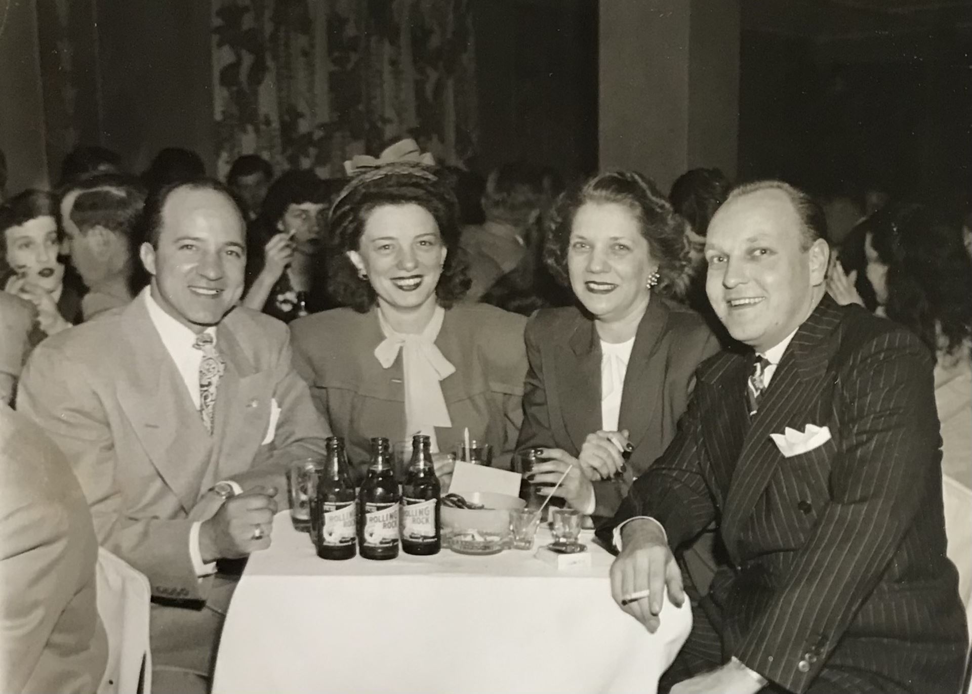 Frank Tito (far left) and family members out on the town with Rolling Rock beer bottles arrayed on a table. Photo courtesy of Rona Peckich.