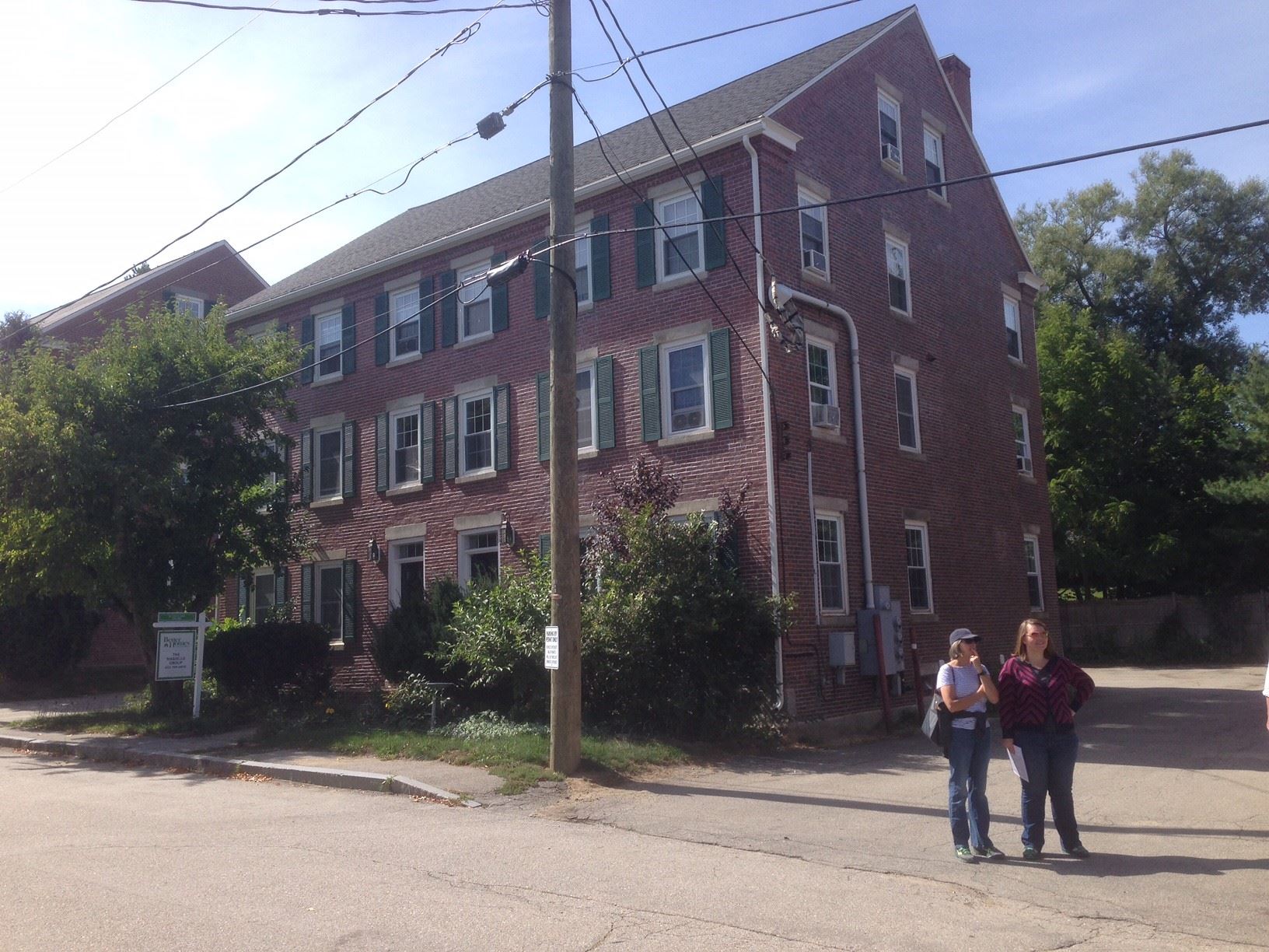 Members of the New England Chapter of the VAF examine worker housing in a textile mill village.