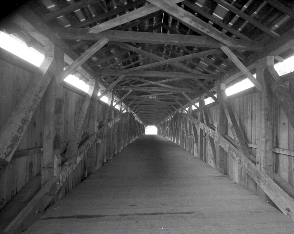 Fig. 5. “Barrel” shot inside the Beech Fork Bridge, showing the trusses, deck, and upper lateral bracing. Photo courtesy of author.